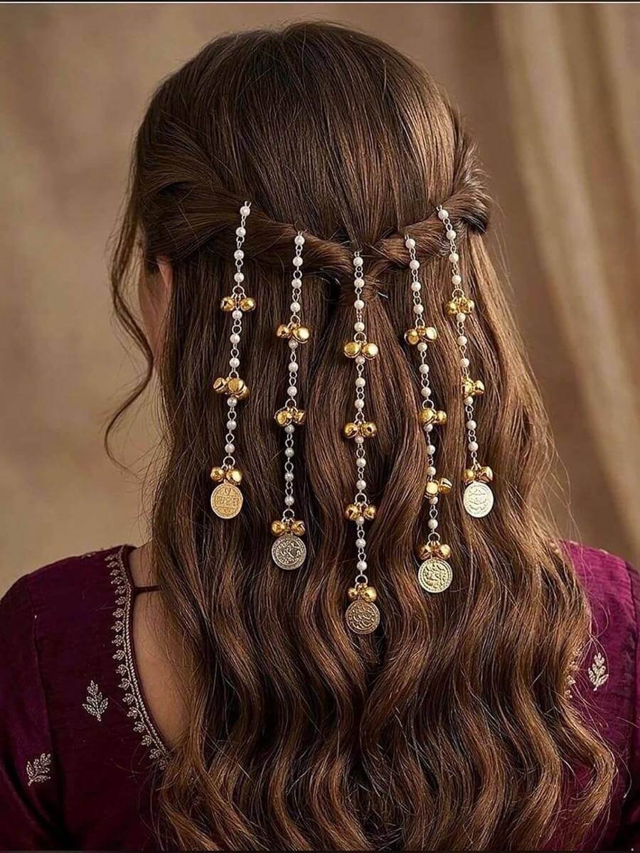 Beaded hair chains with gold coin drops worn through loose waves