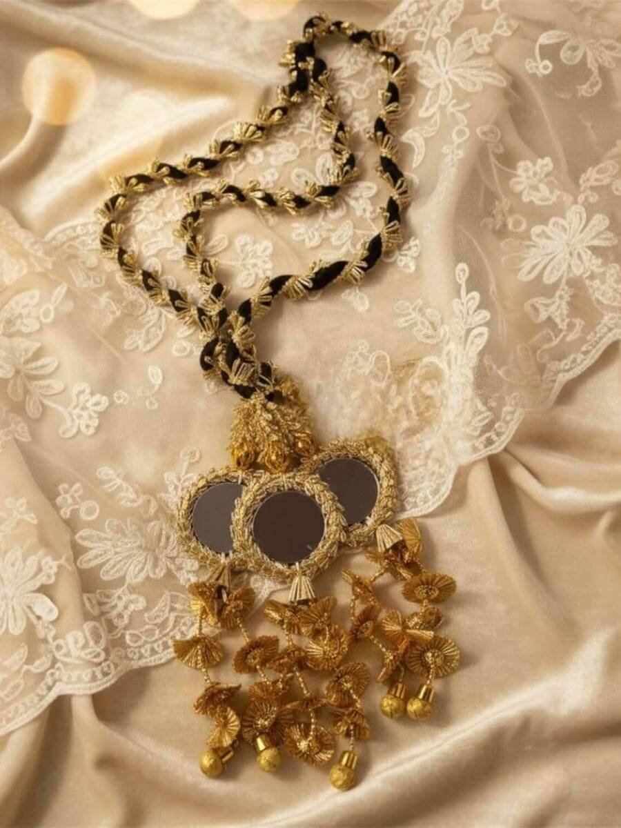 Black and gold cord paranda with a mirror pendant and gold tassels