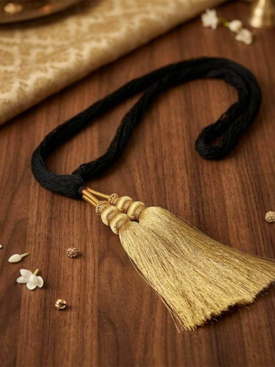 Black cord parandi finished with a golden silk tassel